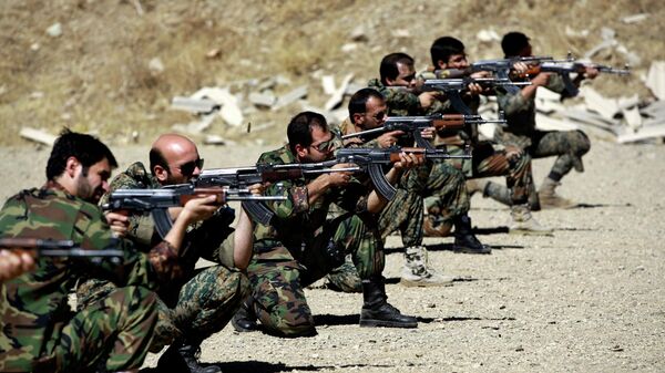 In this Thursday, Sept. 19, 2013 photo, members of the Basij paramilitary militia fire their weapons during a training session, in Tehran, Iran - Sputnik International