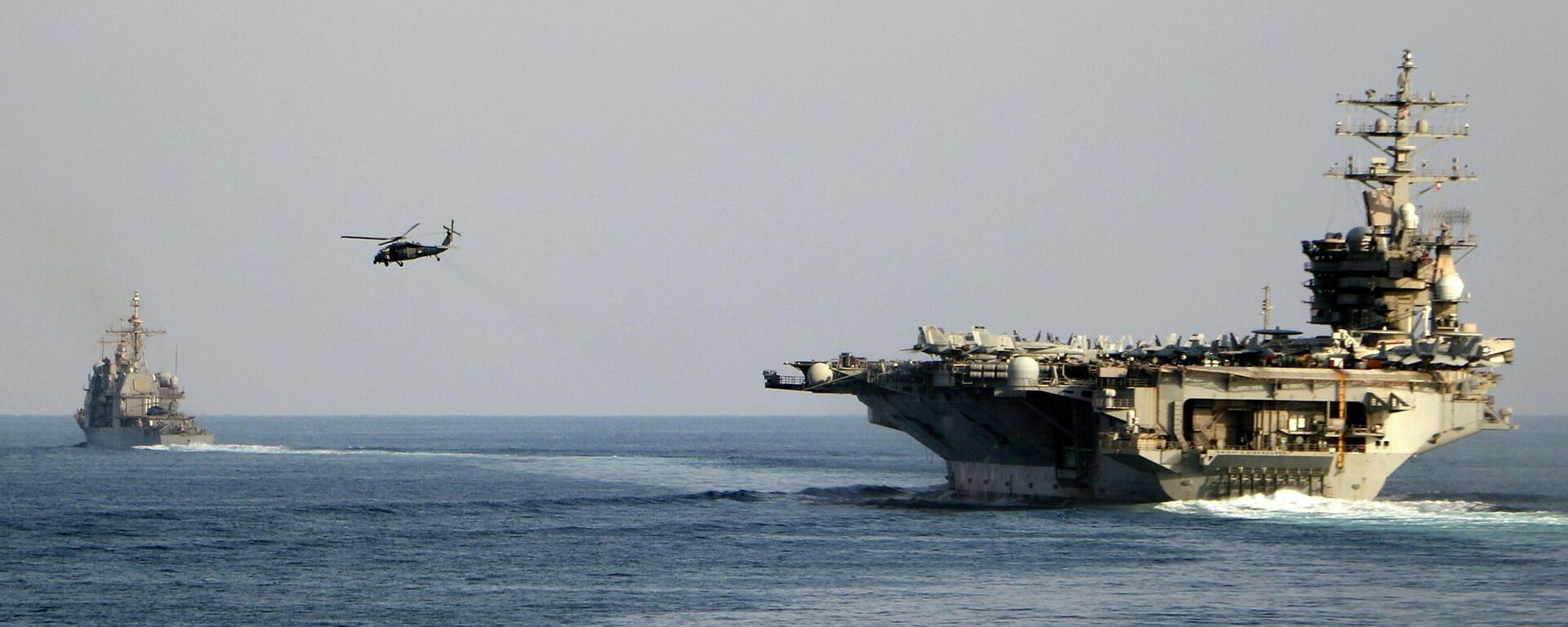 The aircraft carrier USS Dwight D. Eisenhower and other warships crosses the Strait of Hormuz into the Persian Gulf on Sunday. File photo. - Sputnik International, 1920, 13.04.2026