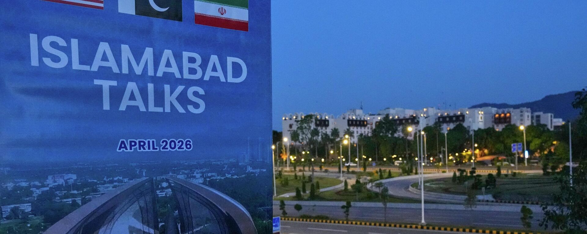 A billboard of the U.S. Iran talks is seen near Serena Hotel, the venue for the U.S. Iran officials meeting, in Islamabad, Pakistan, Sunday, April 12, 2026. (AP Photo/Anjum Naveed) - Sputnik International, 1920, 23.04.2026