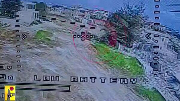 Screenshot of video released by Hezbollah's media office showing attack on Israeli armor in southern Lebanon. - Sputnik International