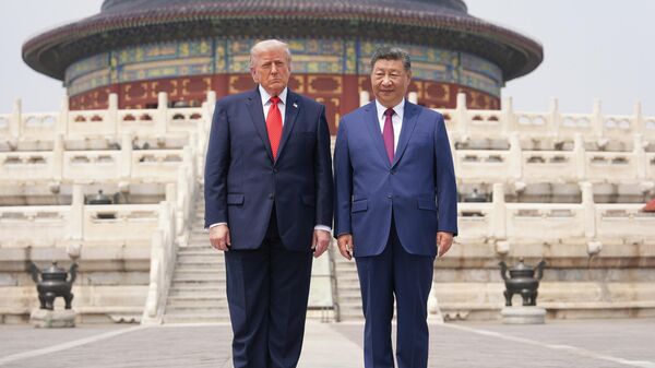 President Donald Trump, left, stands with Chinese President Xi Jinping at the Temple of Heaven on Thursday May 14, 2026, in Beijing - Sputnik International