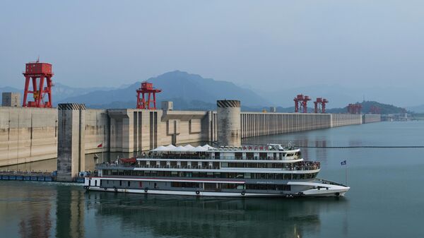 A tourist cruise sails out from the Three Gorges Dam during a sightseeing tour on the Yangtze River near Yichang in central China's Hubei Province, Wednesday, May 21, 2025. - Sputnik International