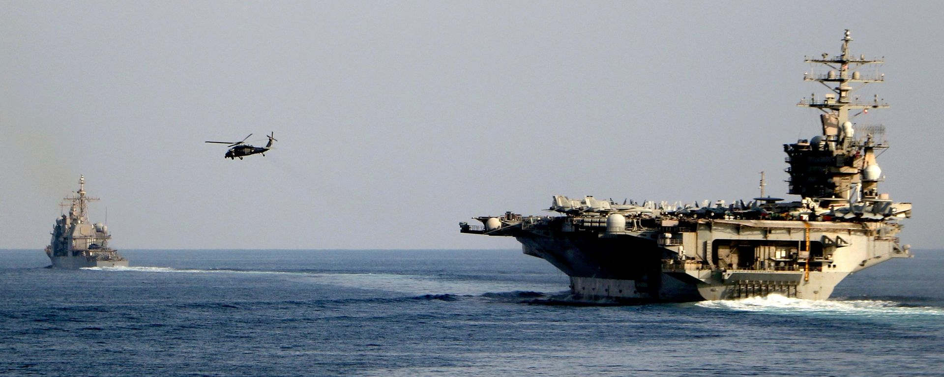The aircraft carrier USS Dwight D. Eisenhower and other warships crosses the Strait of Hormuz into the Persian Gulf on Sunday, Nov. 26, 2023 - Sputnik International, 1920, 15.07.2026
