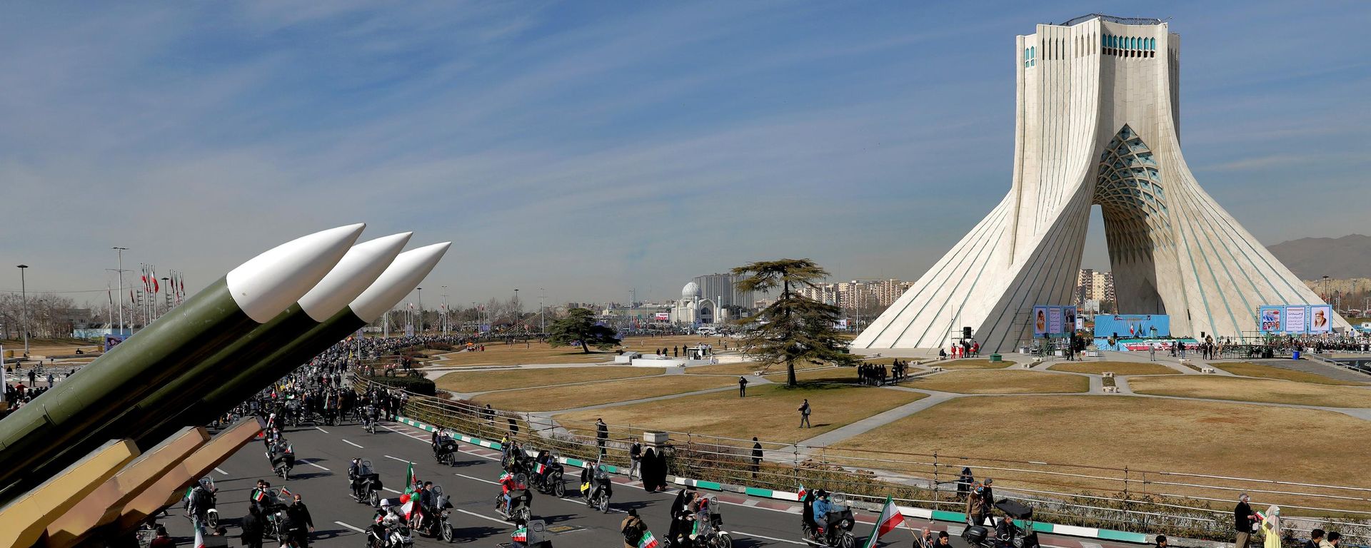 Iranians drive past missiles by their motorcycle during a rally marking the 42nd anniversary of the Islamic Revolution, at Azadi (Freedom) Square in Tehran, Iran, Wednesday, Feb. 10, 2021 - Sputnik International, 1920, 27.07.2026