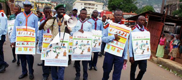 UNICEF members are holding posters detailing Ebola virus symptoms, Freetown, Sierra Leone. UNICEF members are holding posters detailing Ebola virus symptoms, Freetown, Sierra Leone. - Sputnik International