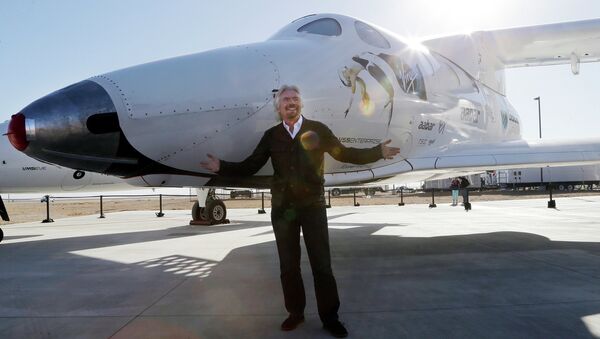 British entrepreneur Richard Branson poses with SpaceShipTwo at a Virgin Galactic hangar at Mojave Air and Space Port in Mojave, Calif. - Sputnik International