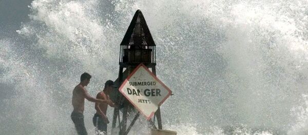 This Sept 14, 1999 file photo shows Fort Lauderdale, Fla., residents Rafael Verga, left, and Joel Vasconcelos, right, holding on as waves hit the jetty at Haulover Beach in Miami Beach, Fla., as Hurricane Floyd moves toward South Florida. Sea levels rising because of global warming, along with increased storminess as the climate changes, will expose tens of millions of people in the world's port cities to coastal flooding, says a report by the Organization for Economic Cooperation and Development. This Sept 14, 1999 file photo shows Fort Lauderdale, Fla., residents Rafael Verga, left, and Joel Vasconcelos, right, holding on as waves hit the jetty at Haulover Beach in Miami Beach, Fla., as Hurricane Floyd moves toward South Florida. Sea levels rising because of global warming, along with increased storminess as the climate changes, will expose tens of millions of people in the world's port cities to coastal flooding, says a report by the Organization for Economic Cooperation and Development. - Sputnik International