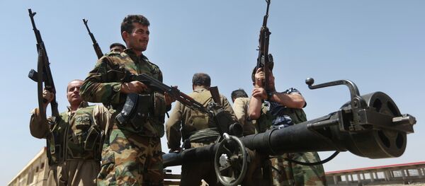Kurdish peshmerga fighters take positions on the front line with militants from the al-Qaida-inspired Islamic State in Iraq and the Levant (ISIL), in Tuz Khormato, 100 kilometers (62 miles) south of the oil rich province of Kirkuk, northern Iraq, Wednesday, June 25, 2014 - Sputnik International