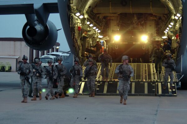 Soldiers from the 2nd Platoon, Alpha Company, 1-27 Infantry Division, assume a security perimeter as two M1126 Stryker Infantry Carrier Vehicles exit a C-17 Globemaster and drive onto the tarmac at Daegu Air Base, South Korea Soldiers from the 2nd Platoon, Alpha Company, 1-27 Infantry Division, assume a security perimeter as two M1126 Stryker Infantry Carrier Vehicles exit a C-17 Globemaster and drive onto the tarmac at Daegu Air Base, South Korea - Sputnik International