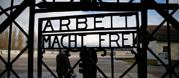 The main gate of the former Dachau concentration camp with the sign Arbeit macht frei (work sets you free) is seen in Dachau, near Munich, in this January 25, 2014 file picture. - Sputnik International