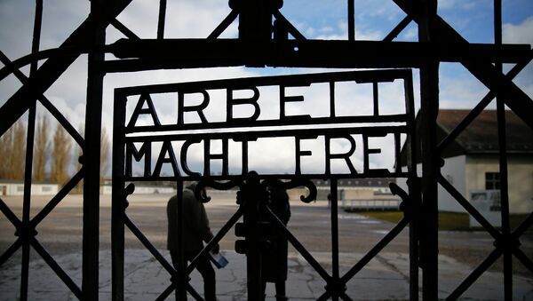 The main gate of the former Dachau concentration camp with the sign Arbeit macht frei (work sets you free) is seen in Dachau, near Munich, in this January 25, 2014 file picture. - Sputnik International