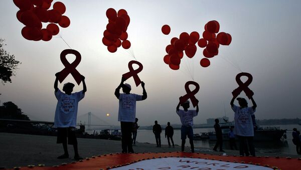 Children display ribbon cut-outs tied to balloons during an HIV/AIDS awareness campaign to mark World AIDS Day in Kolkata December 1, 2014. The world has finally reached the beginning of the end of the AIDS pandemic that has infected and killed millions in the past 30 years, according to a leading campaign group fighting HIV. United Nations data show that in 2013, 35 million people were living with HIV, 2.1 million people were newly infected with the virus and some 1.5 million people died of AIDS. By far the greatest part of the HIV/AIDS burden is in sub-Saharan Africa. - Sputnik International