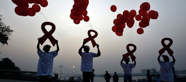 Children display ribbon cut-outs tied to balloons during an HIV/AIDS awareness campaign to mark World AIDS Day in Kolkata December. File photo - Sputnik International