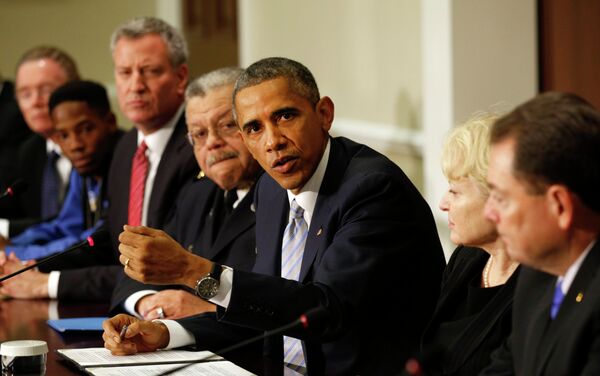 U.S. President Barack Obama speaks during a meeting with elected officials, community and faith leaders and law enforcement officials at the White House in Washington December 1, 2014. The meeting was held to to discuss how communities and law enforcement can work together to build trust to strengthen neighborhoods across the country. Obama asked Congress on Monday for $263 million for the federal response to the civil rights upheaval in Ferguson, Missouri, and is setting up a task force to study how to improve modern-day policing. Beside Obama are Philadelphia Police Commissioner Charles Ramsey (4th L) and New York Mayor Bill de Blasio (3rd L). - Sputnik International
