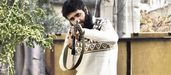 Yusef Sarwar holding a gun Yusef Sarwar holding a gun - Sputnik International