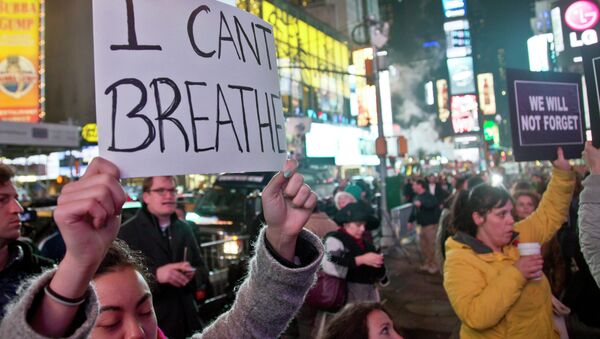 Protesters in Times Square carry signs in reaction to a non indictment against a police officer in the death of Eric Garner, Wednesday Dec. 3, 2014 in New York. Protesters in Times Square carry signs in reaction to a non indictment against a police officer in the death of Eric Garner, Wednesday Dec. 3, 2014 in New York. - Sputnik International