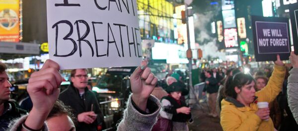 Protesters in Times Square carry signs in reaction to a non indictment against a police officer in the death of Eric Garner, Wednesday Dec. 3, 2014 in New York. - Sputnik International
