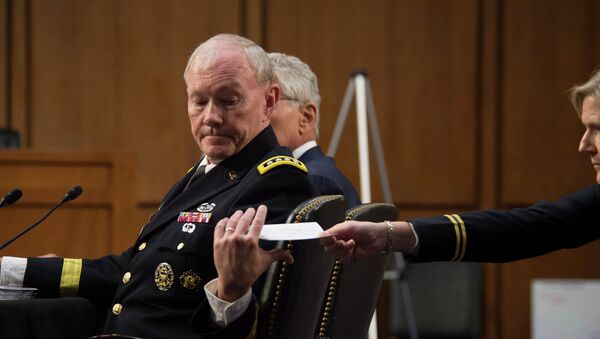 Chairman of the Joint Chiefs of Staff Gen. Martin E. Dempsey receives a note from a member of his staff during a hearing before the Senate Armed Services Committee in Washington D.C. - Sputnik International