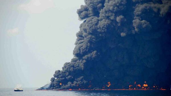 This June 22, 2010 photo shows response crews gathering and burning oil in the Gulf of Mexico near the site of the leaking Macondo Prospect oil field well. - Sputnik International