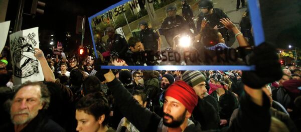 Members of the Berkeley Police Department are reflected in a mirror held up by a protester during a march against the New York City grand jury decision to not indict in the death of Eric Garner in Berkeley, California - Sputnik International