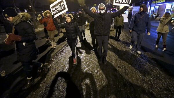 Protesters march during a rally near the Chicago Police headquarters after the announcement of the grand jury decision not to indict police officer Darren Wilson in the fatal shooting of Michael Brown, an unarmed black 18-year old, Monday, Nov. 24, 2014, in Chicago. - Sputnik International