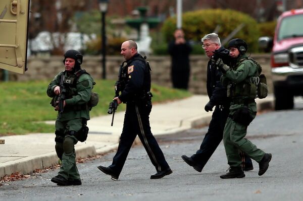 Police move near the scene of a shooting Monday, Dec. 15, 2014, in Souderton, PA. Police were surrounding a home in Souderton, outside Philadelphia, where a suspect was believed to have barricaded himself after shootings at multiple homes. Police tell WPVI-TV the man is suspected of killing at least five people Monday morning at three different homes northwest of Philadelphia.   - Sputnik International