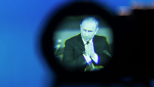 Russian President Vladimir Putin seen gesturing in a camera viewfinder during his annual news conference in Moscow, Russia, Thursday, Dec. 18, 2014. The Russian economy will rebound and the ruble will stabilize, Russian President Vladimir Putin said Thursday at his annual press conference, he also said Ukraine must remain one political entity, voicing hope that the crisis could be solved through peace talks. - Sputnik International