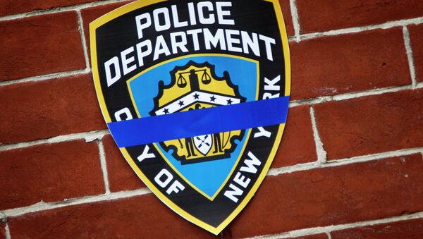 An NYPD logo is pictured on wall above makeshift memorial at the site where two police officers were shot in the head in the Brooklyn borough of New York, December 22, 2014. - Sputnik International