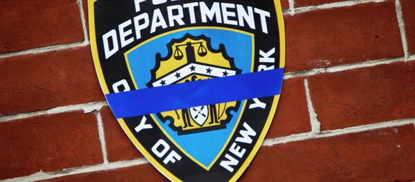 An NYPD logo is pictured on wall above makeshift memorial at the site where two police officers were shot in the head in the Brooklyn borough of New York, December 22, 2014. - Sputnik International