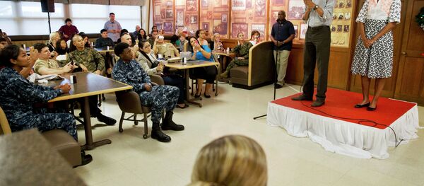 President Barack Obama, with first lady Michelle Obama, greets troops and their families on Christmas Day, Thursday, Dec. 25, 2014, at Marine Corps Base Hawaii in Kaneohe Bay, Hawaii during the Obama family vacation. - Sputnik International