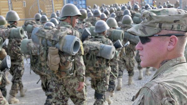 U.S. Army Cpl. William Metz, a Clearwater, Fla., native, now a team leader and adviser with 3rd Battalion, 4th Infantry Regiment, 170th Infantry Brigade Combat Team, watches as Afghan National Army recruits finish a march at the Kabul Military Training Center - Sputnik International