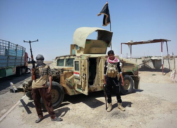 In this file photo, Islamic State group militants stand with a captured Iraqi army Humvee at a checkpoint outside Beiji refinery, around 155 miles north of Baghdad, Iraq. In this file photo, Islamic State group militants stand with a captured Iraqi army Humvee at a checkpoint outside Beiji refinery, around 155 miles north of Baghdad, Iraq. - Sputnik International