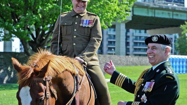 His Royal Highness Prince Andrew, The Duke of York shares a joke with Lt.-Col. Kevin Winiarski, a member of the ‘Old Guard’ of the Queen's York Rangers, during a parade at the Fort York National Historic Site in Toronto on June 05, 2014 - Sputnik International
