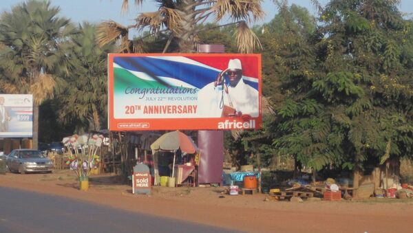 A giant billboard of President Yahya Jammeh, of the Gambia, sits on an empty street in Banjul. - Sputnik International
