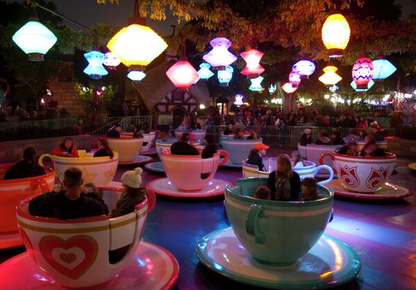 Visitors spinning around in giant pastel teacups on the Mad Tea Party ride at Disneyland Park in California. Visitors spinning around in giant pastel teacups on the Mad Tea Party ride at Disneyland Park in California. - Sputnik International