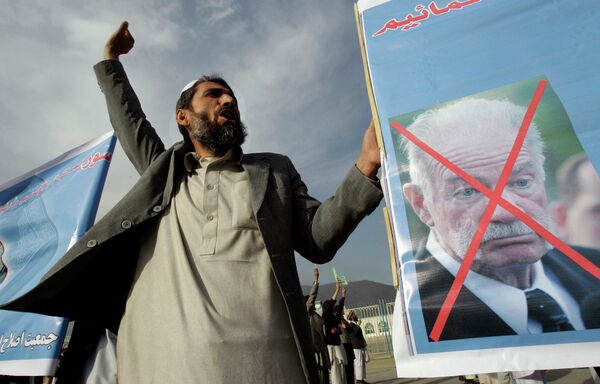 An Afghani man shouts anti America slogans as he holds a poster of Florida pastor Terry Jones during a peaceful protest in Kabul, Afghanistan, Thursday April 7, 2011. Clerics at a peaceful protest of about 300 people in Kabul say a U.S. pastor who burned a Quran should be prosecuted and Americans should withdraw from Afghanistan. The writing on the poster read Civil Association . An Afghani man shouts anti America slogans as he holds a poster of Florida pastor Terry Jones during a peaceful protest in Kabul, Afghanistan, Thursday April 7, 2011. Clerics at a peaceful protest of about 300 people in Kabul say a U.S. pastor who burned a Quran should be prosecuted and Americans should withdraw from Afghanistan. The writing on the poster read Civil Association . - Sputnik International