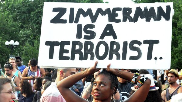 A woman holds a sign at a protest in New York City after the acquittal of George Zimmerman - Sputnik International