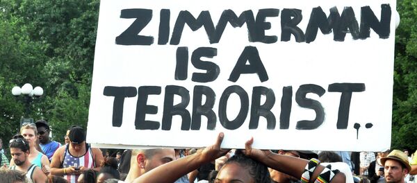 A woman holds a sign at a protest in New York City after the acquittal of George Zimmerman - Sputnik International