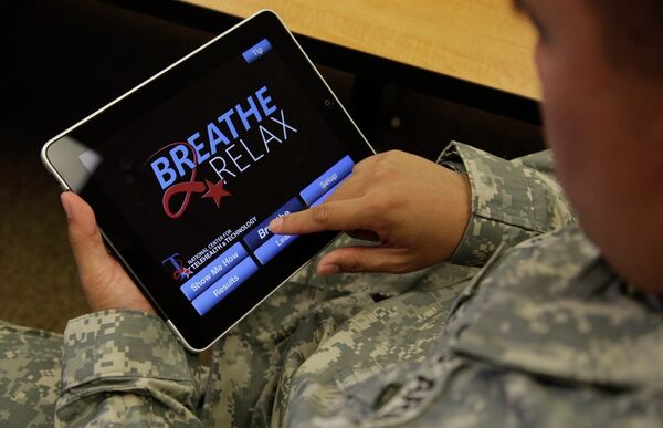 Sgt. Mark Miranda, a public affairs specialist stationed at Joint Base Lewis-McChord in Washington state, demonstrates the use of a program for tablet computers and smart phones that is designed to help calm symptoms of post-traumatic stress and traumatic brain injury, Friday, July 22, 2011. Miranda said he does not suffer from PTSD, but after trying the app, he said he may suggest its use to other soldiers who he has deployed with. Sgt. Mark Miranda, a public affairs specialist stationed at Joint Base Lewis-McChord in Washington state, demonstrates the use of a program for tablet computers and smart phones that is designed to help calm symptoms of post-traumatic stress and traumatic brain injury, Friday, July 22, 2011. Miranda said he does not suffer from PTSD, but after trying the app, he said he may suggest its use to other soldiers who he has deployed with. - Sputnik International