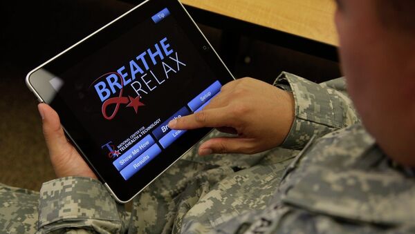 Sgt. Mark Miranda, a public affairs specialist stationed at Joint Base Lewis-McChord in Washington state, demonstrates the use of a program for tablet computers and smart phones that is designed to help calm symptoms of post-traumatic stress and traumatic brain injury, Friday, July 22, 2011. Miranda said he does not suffer from PTSD, but after trying the app, he said he may suggest its use to other soldiers who he has deployed with. - Sputnik International