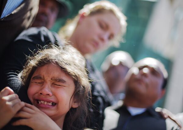 Emma Phonesavanh, the sister of 19-month-old Bounkham Bou Bou Phonesavanh who was severely burned by a flash grenade during a SWAT drug raid, cries while attending a vigil with her parents Alecia and Boun Khan Phonesavanh, rear left and right, outside Atlanta's Grady Memorial Hospital where he was undergoing treatment on June 2, 2014. Emma Phonesavanh, the sister of 19-month-old Bounkham Bou Bou Phonesavanh who was severely burned by a flash grenade during a SWAT drug raid, cries while attending a vigil with her parents Alecia and Boun Khan Phonesavanh, rear left and right, outside Atlanta's Grady Memorial Hospital where he was undergoing treatment on June 2, 2014. - Sputnik International