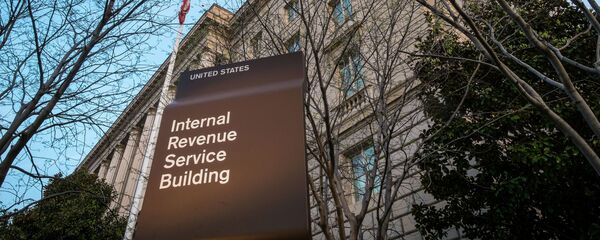 In this April 13, 2014 file photo, the Internal Revenue Service Headquarters (IRS) building is seen in Washington. The IRS is cutting taxpayer services to historically low levels just as President Barack Obama's health law will make filing a federal tax return more complicated for millions of families. In this April 13, 2014 file photo, the Internal Revenue Service Headquarters (IRS) building is seen in Washington. The IRS is cutting taxpayer services to historically low levels just as President Barack Obama's health law will make filing a federal tax return more complicated for millions of families. - Sputnik International
