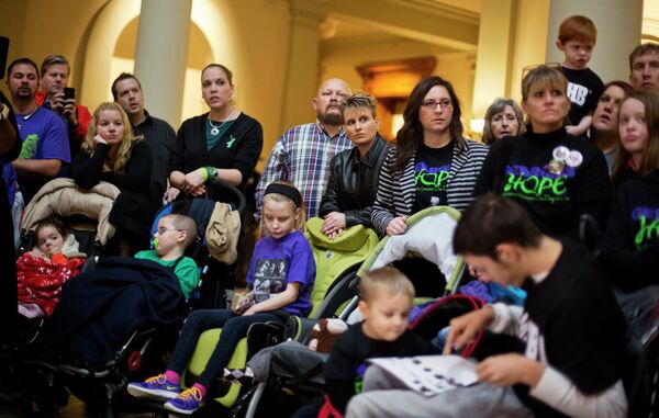 This Jan. 13, 2015 file photo, shows parents of children who suffer from epilepsy. With virtually no hard proof that medical marijuana benefits sick children, and evidence that it may harm developing brains, the drug should only be used for severely ill kids who have no other treatment option, the nation's most influential pediatricians group says in a new policy.  - Sputnik International