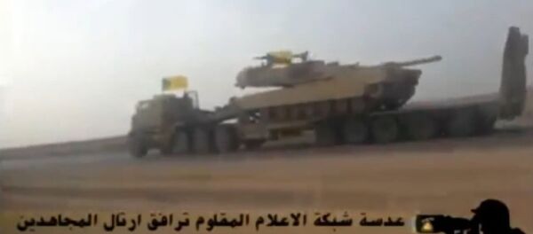 In this screenshot from a video uploaded to YouTube, a Hezbollah Brigades convoy transports an American-made M1 Abrams tank to the front lines of the battle with ISIL. In this screenshot from a video uploaded to YouTube, a Hezbollah Brigades convoy transports an American-made M1 Abrams tank to the front lines of the battle with ISIL. - Sputnik International