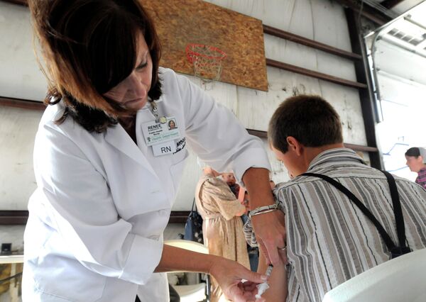 A health worker administers a measles vaccine in rural Ohio in 2014, where a measles outbreak of over 300 cases was the largest in the U.S. since 1994. A health worker administers a measles vaccine in rural Ohio in 2014, where a measles outbreak of over 300 cases was the largest in the U.S. since 1994. - Sputnik International