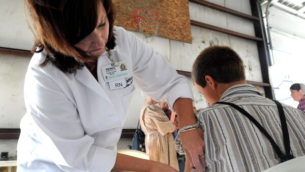 A health worker administers a measles vaccine in rural Ohio in 2014, where a measles outbreak of over 300 cases was the largest in the U.S. since 1994. - Sputnik International