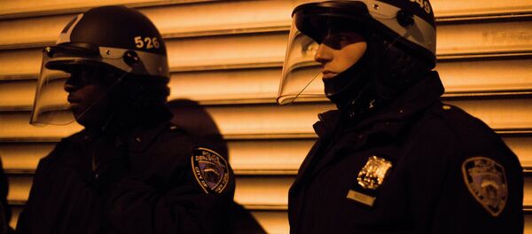 NYPD crowd control officers keep watch on a march of demonstrators as they protest against the shooting of Kimani Kiki Gray on Thursday, March 14, 2013 in the East Flatbush neighborhood of Brooklyn, N.Y. The 16-year-old was shot to death on a Brooklyn street last Saturday night by plainclothes police officers who claim the youth pointed a .38-caliber revolver at them, while the family says Gray was unarmed. - Sputnik International