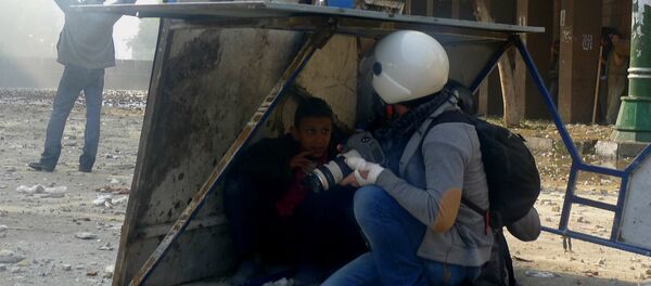 Journalist and boy take cover from stones thrown by rooftop militia Journalist and boy take cover from stones thrown by rooftop militia - Sputnik International
