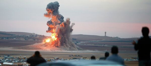 Smoke and flames rise over a hill near the Syrian town of Kobani after an airstrike. Smoke and flames rise over a hill near the Syrian town of Kobani after an airstrike. - Sputnik International