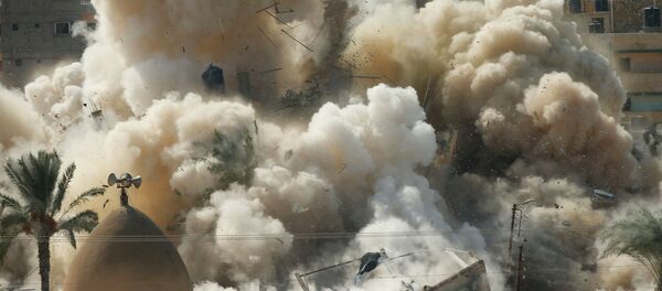 Smoke rises after a house is blown up during a military operation by Egyptian security forces in the Egyptian city of Rafah, near the border with southern Gaza Strip October 29, 2014. At least 33 Egyptian security personnel were killed on Friday in the Sinai Peninsula bordering Israel and Gaza, in an attack on a checkpoint that bore the marks of assaults claimed by Egypt's most active militant group Ansar Bayt al-Maqdis - Sputnik International